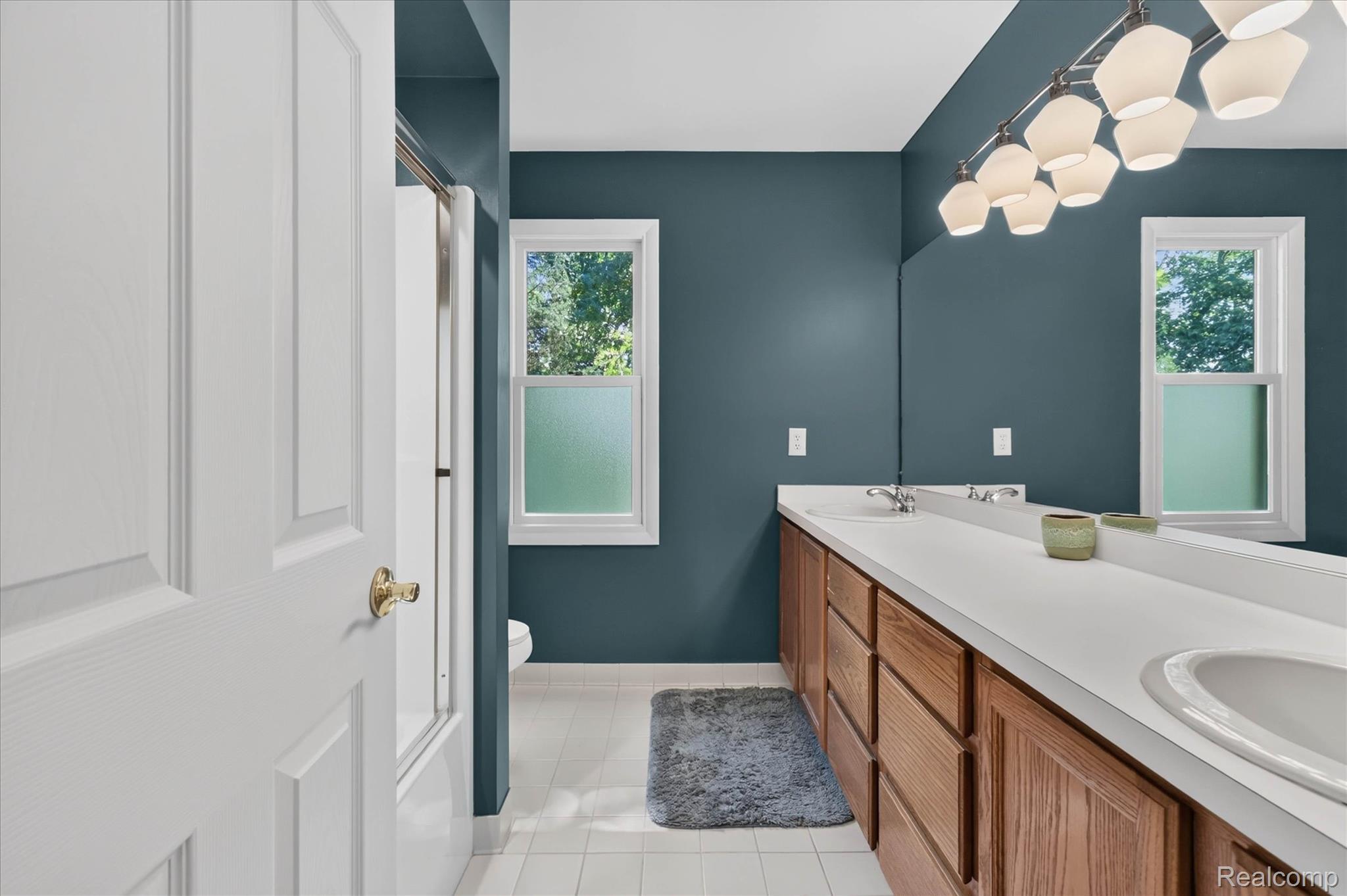 4037 Chilson Road Howell, MI 48843 - Photo 26 of 69 Dual vanity with integrated sinks and wood-finish cabinetry