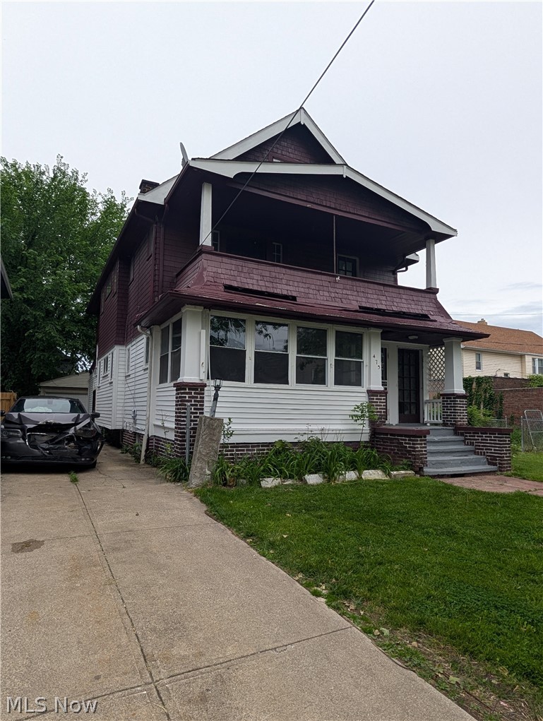 475 East 146th Street Cleveland, OH 44110 - Photo 2 of 28 Two-story residence featuring a covered upper-level balcony and a ground-level covered porch