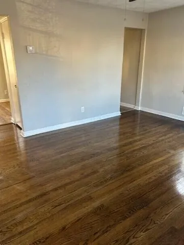 a view of room with wooden floor