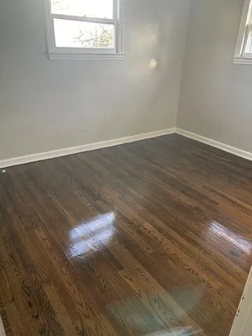 a view of a room with wooden floor and white walls