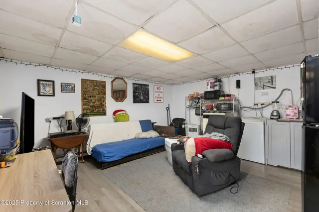 a living room with furniture gym equipment and a flat screen tv