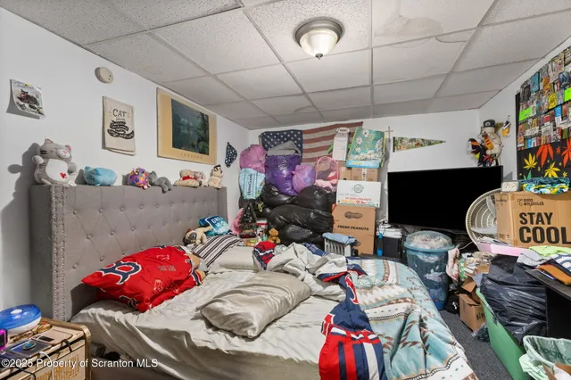 a bedroom with furniture and a flat screen tv