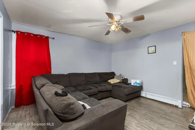 a living room with furniture and wooden floor
