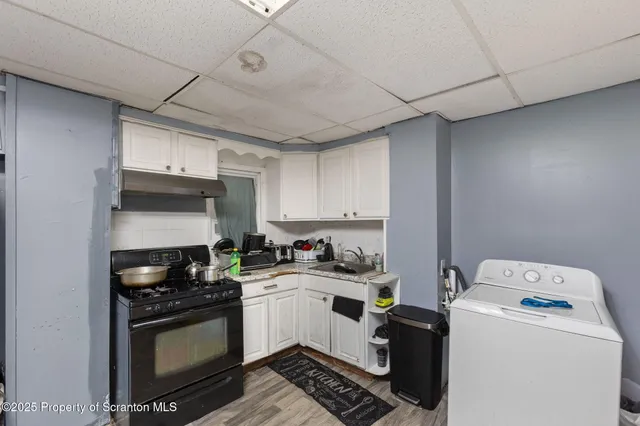 a kitchen with a sink a stove and cabinets