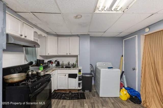 a kitchen with a stove a refrigerator and a sink