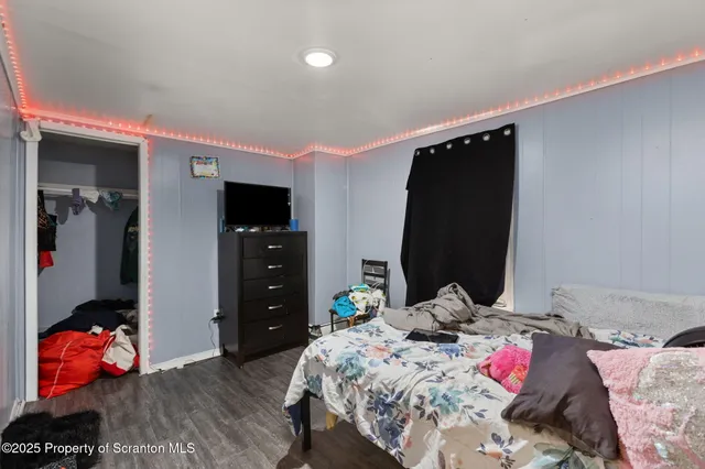 a bedroom with a bed and a television