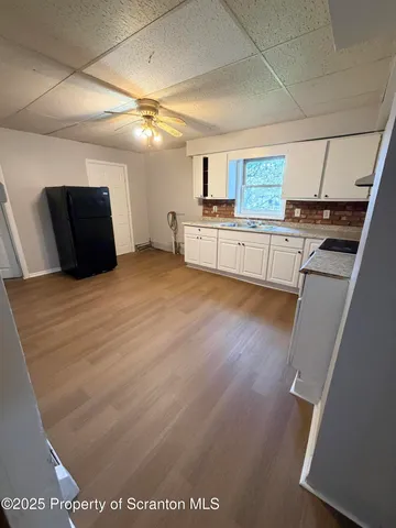 a large white kitchen with cabinets