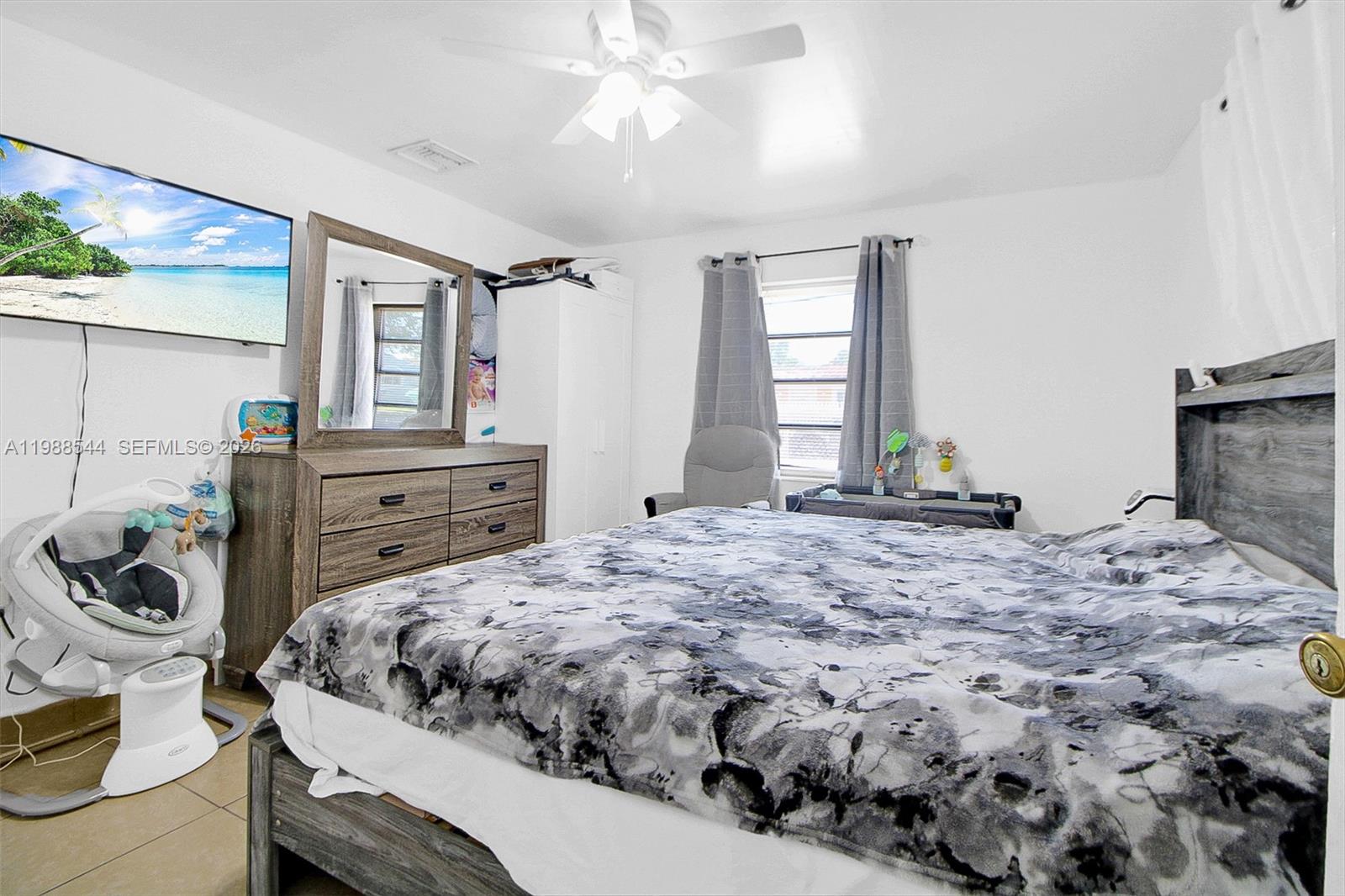 2900 Northwest 95th Street Miami, FL 33147 - Photo 14 of 48 a bedroom with a bed and a dresser