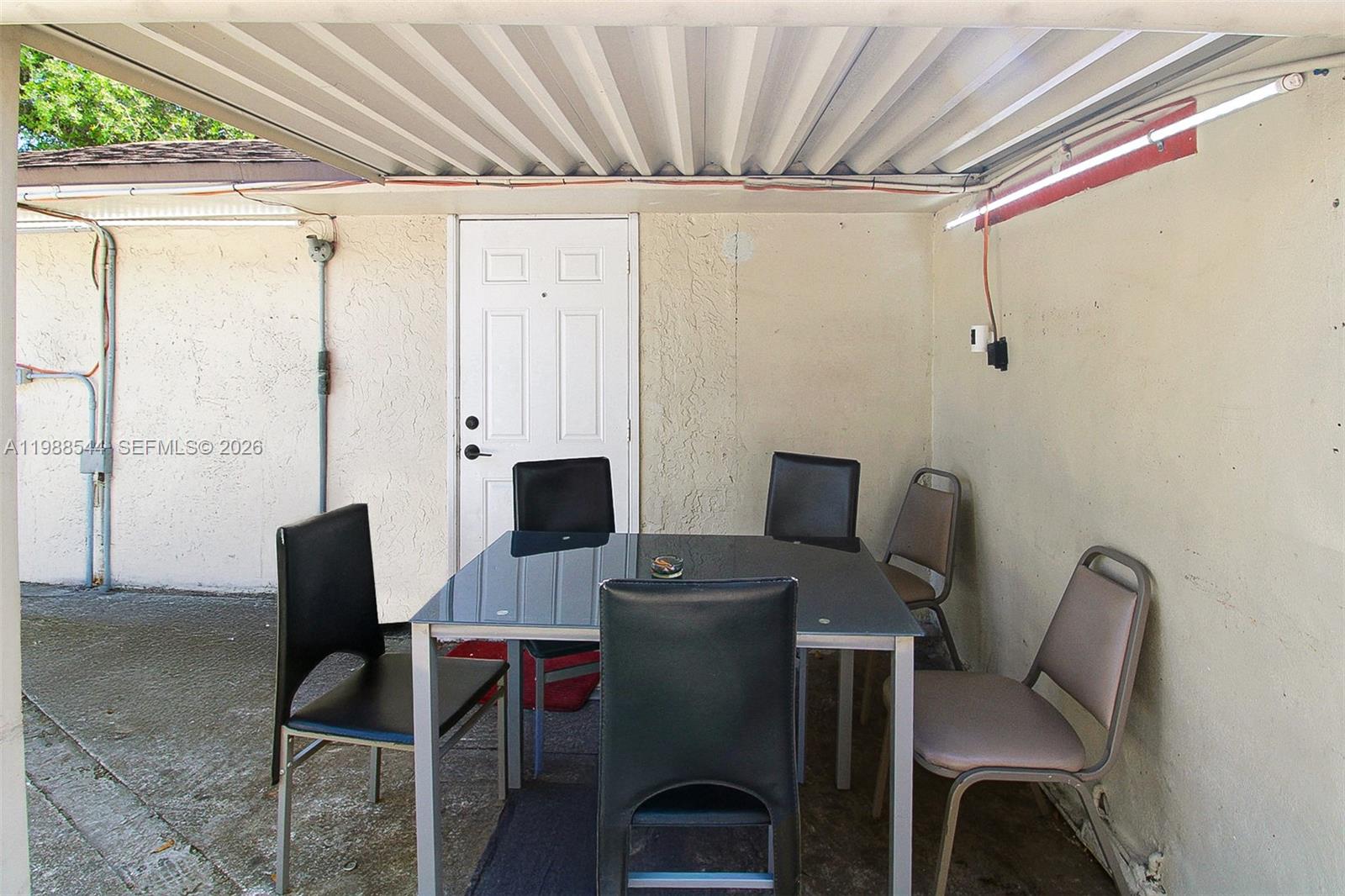 2900 Northwest 95th Street Miami, FL 33147 - Photo 27 of 48 a view of a workspace with furniture and a window