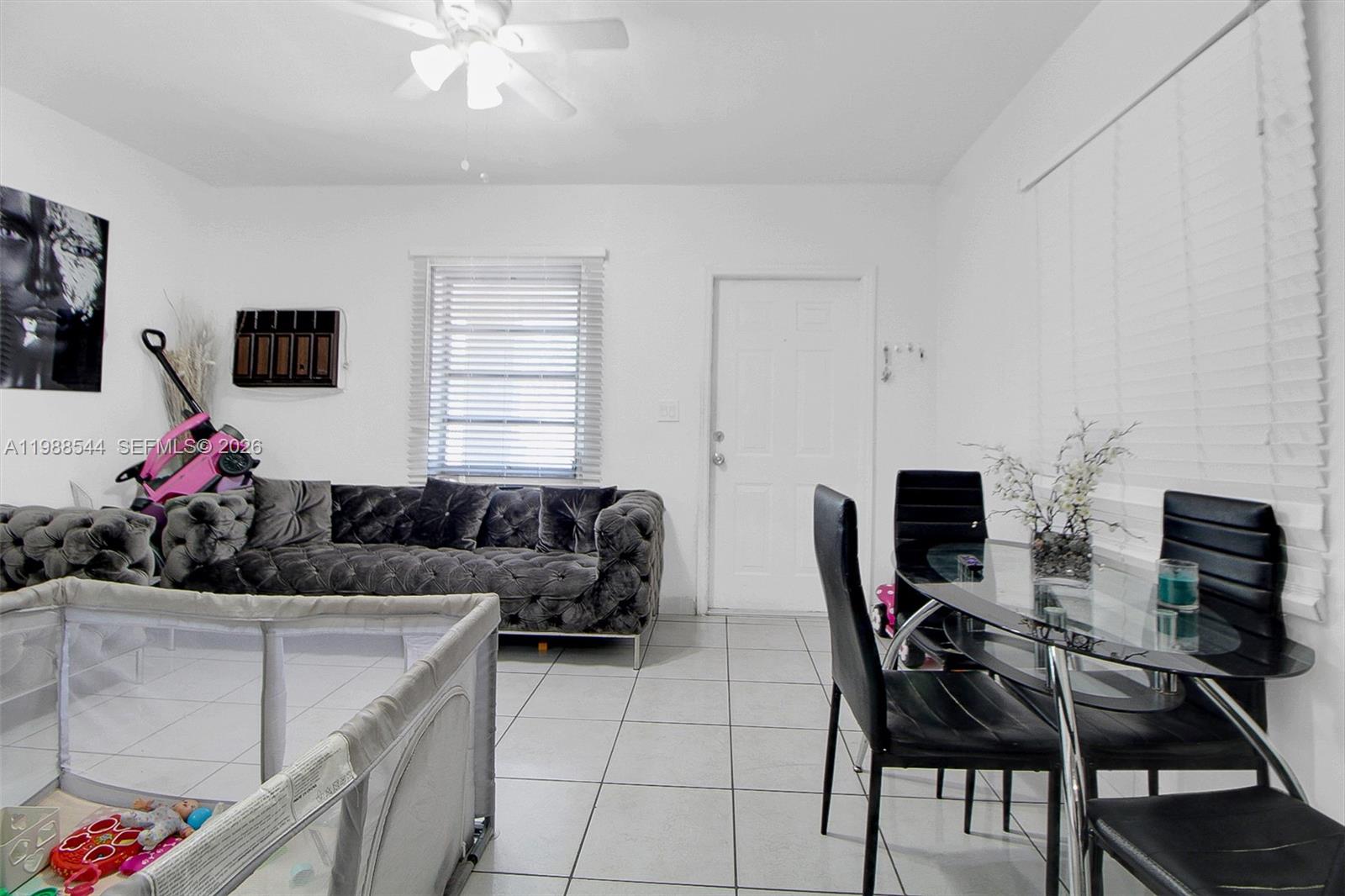 2900 Northwest 95th Street Miami, FL 33147 - Photo 30 of 48 a living room with furniture and a flat screen tv