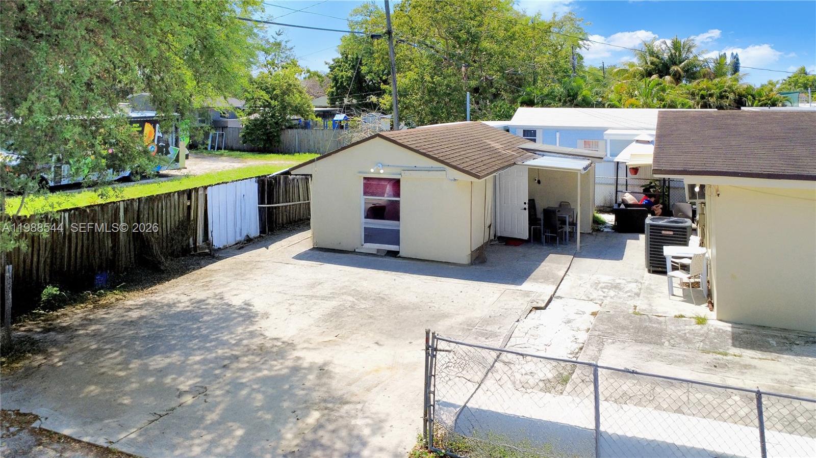 2900 Northwest 95th Street Miami, FL 33147 - Photo 3 of 48 a view of a white house with wooden fence