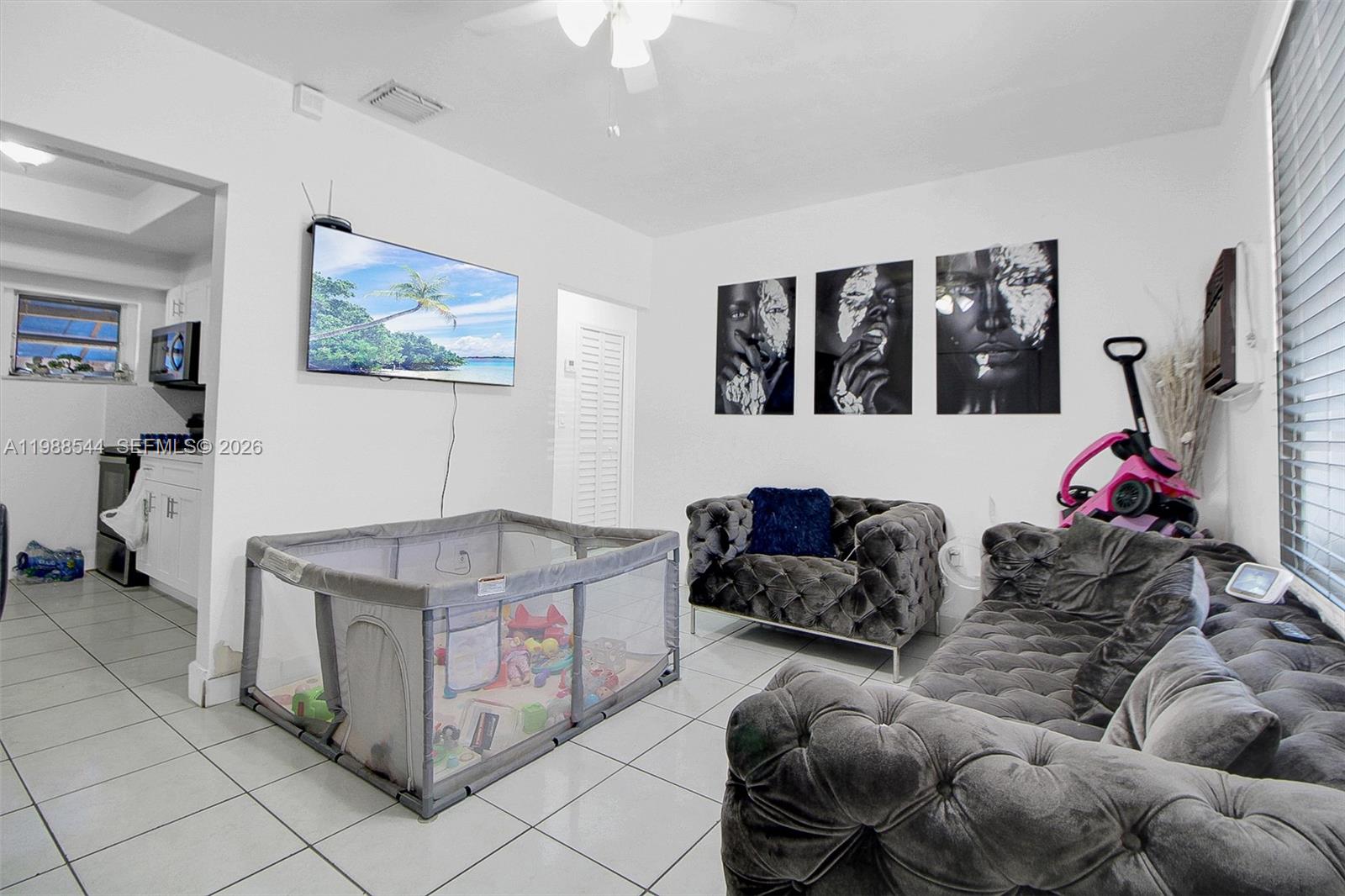 2900 Northwest 95th Street Miami, FL 33147 - Photo 32 of 48 a living room with furniture and a flat screen tv