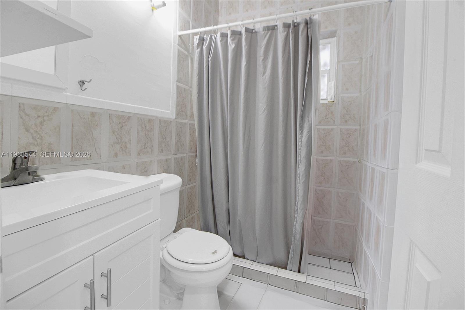 2900 Northwest 95th Street Miami, FL 33147 - Photo 35 of 48 a bathroom with a sink a toilet and shower