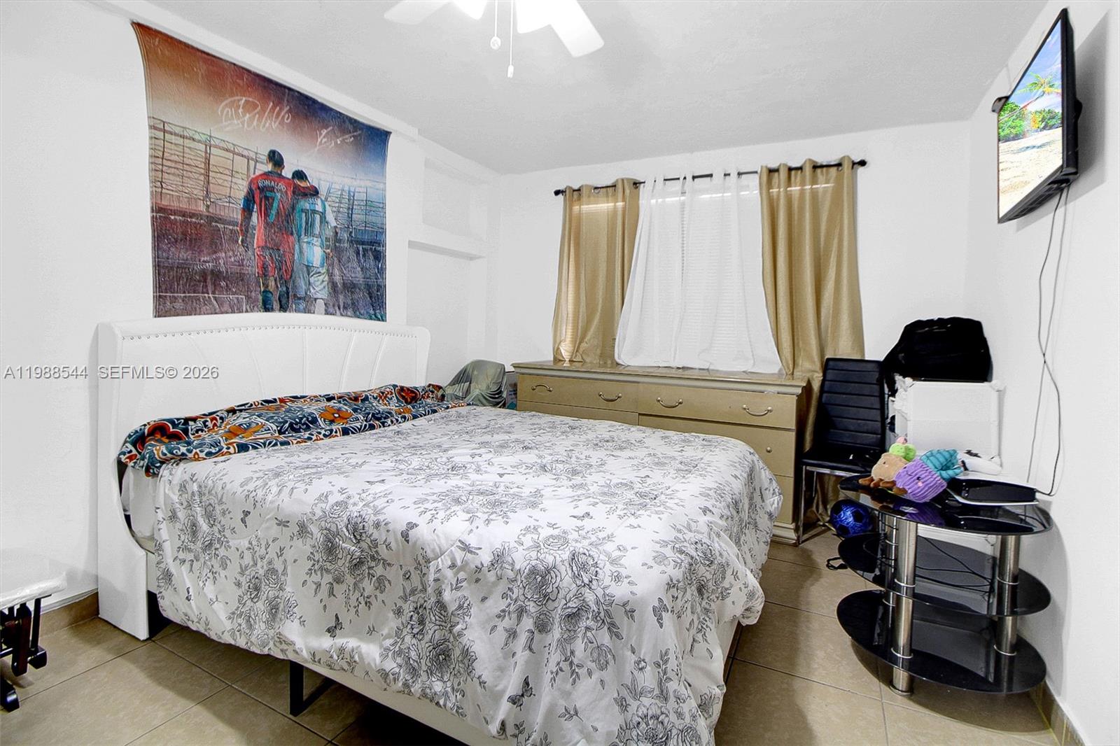 2900 Northwest 95th Street Miami, FL 33147 - Photo 38 of 48 a bedroom with a bed and a flat tv screen on the dresser