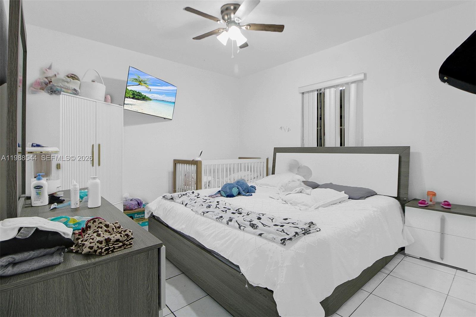 2900 Northwest 95th Street Miami, FL 33147 - Photo 41 of 48 a bedroom with a bed and a chandelier