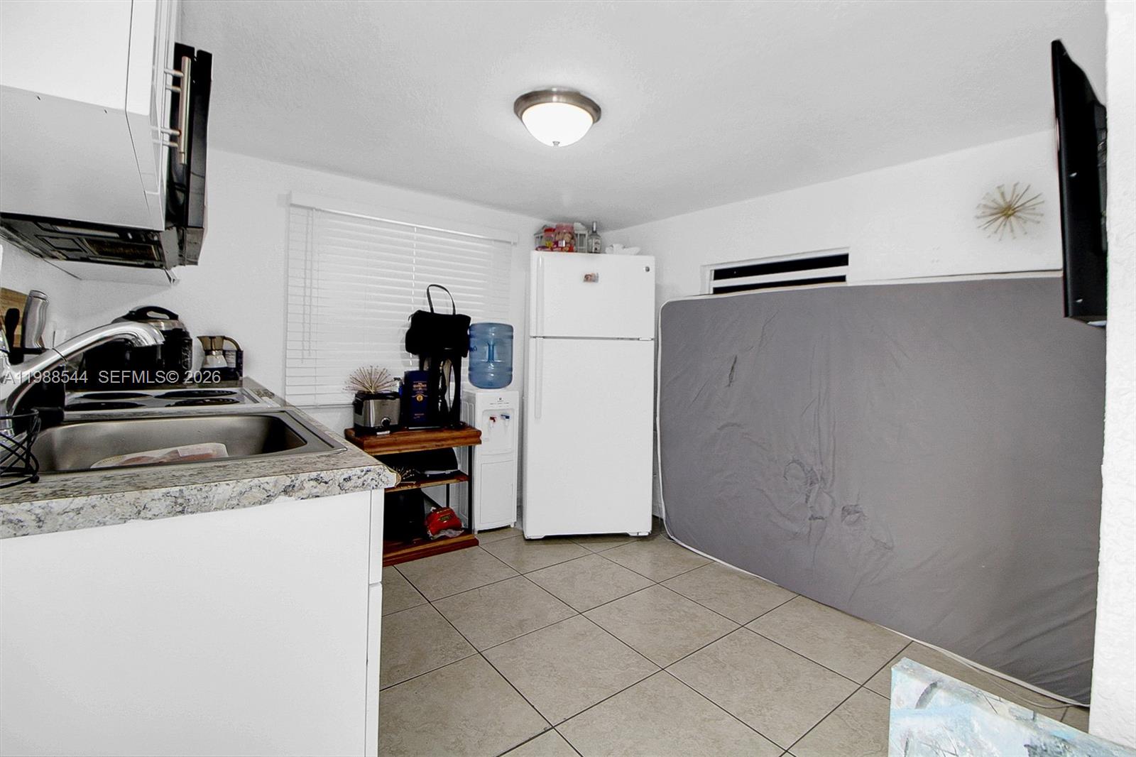2900 Northwest 95th Street Miami, FL 33147 - Photo 5 of 48 a kitchen with a refrigerator and a stove top oven