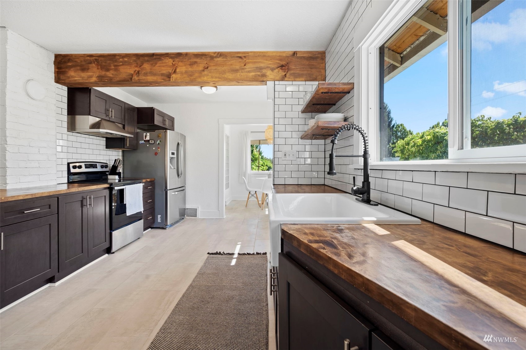 4632 Fawcett Avenue Tacoma, WA 98408 - Photo 11 of 35 a kitchen with stainless steel appliances granite countertop a sink and a stove
