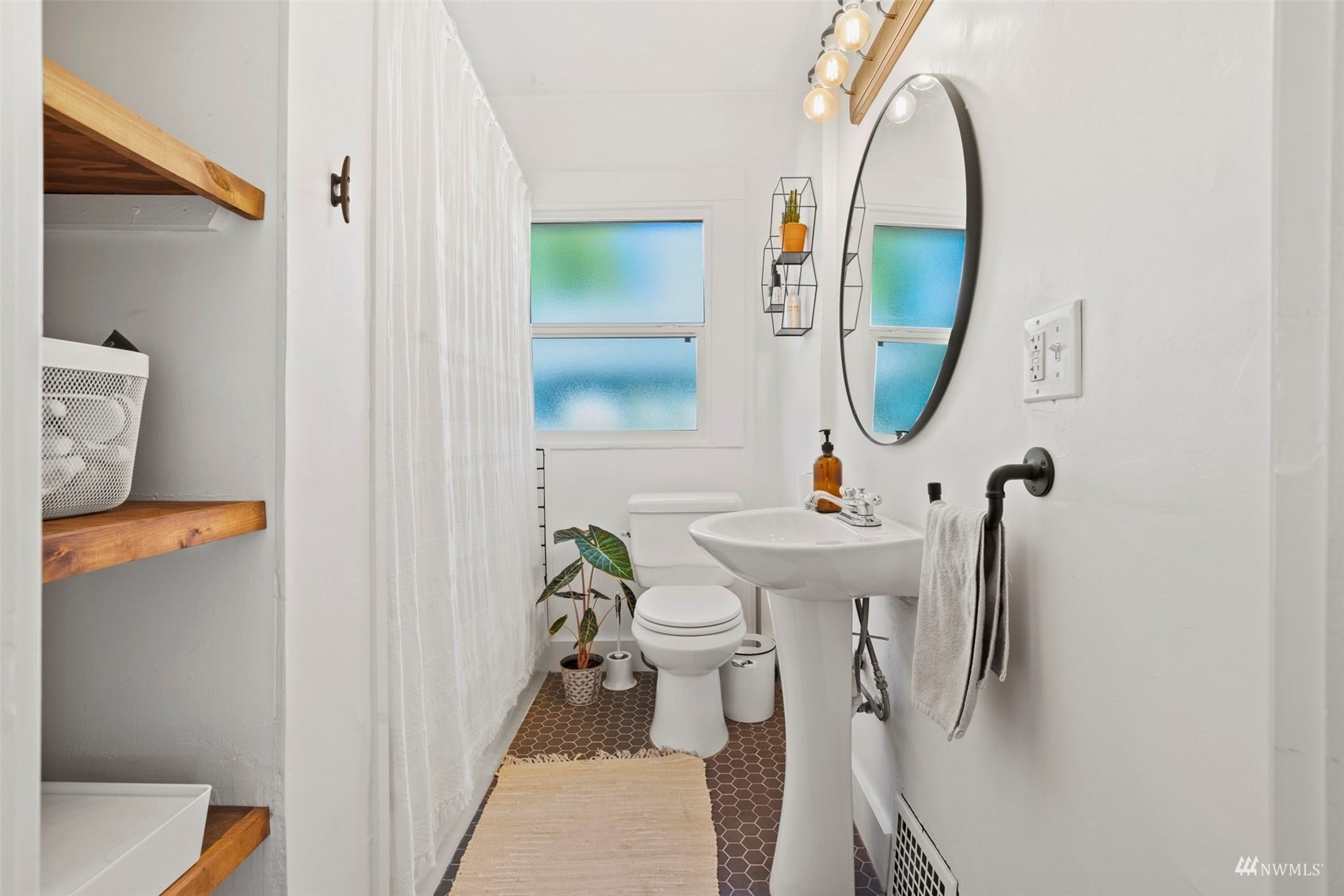 4632 Fawcett Avenue Tacoma, WA 98408 - Photo 19 of 35 a bathroom with a sink a mirror and a toilet
