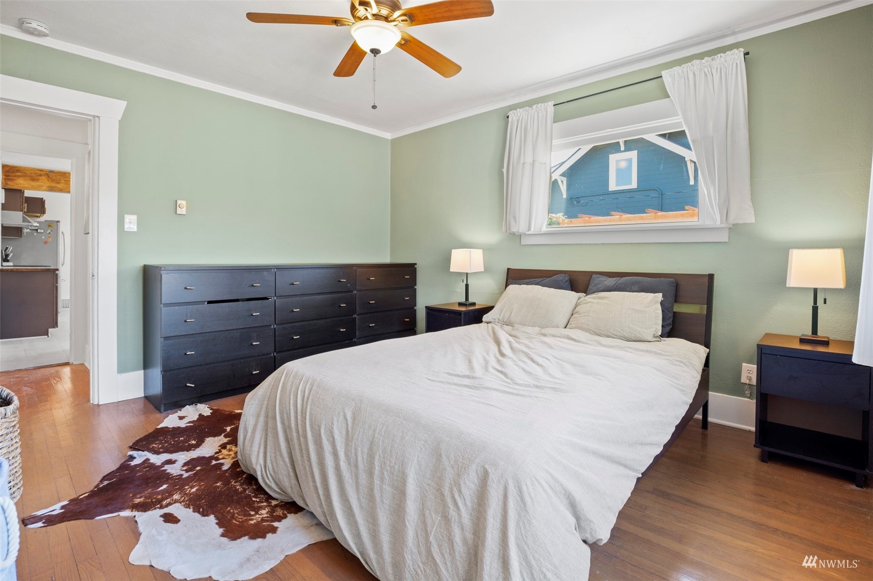 4632 Fawcett Avenue Tacoma, WA 98408 - Photo 23 of 35 a bedroom with a bed and a chandelier