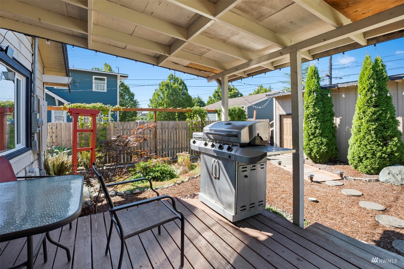 4632 Fawcett Avenue Tacoma, WA 98408 - Photo 27 of 35 a view of a patio with table and chairs potted plants with floor to ceiling window and potted plants