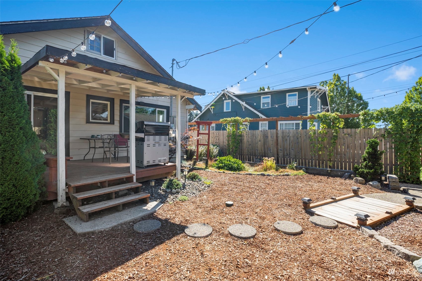 4632 Fawcett Avenue Tacoma, WA 98408 - Photo 29 of 35 a view of a house with a yard and wooden fence