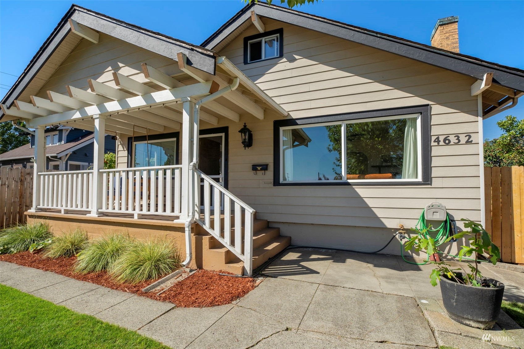 4632 Fawcett Avenue Tacoma, WA 98408 - Photo 3 of 35 a view of a house with a small yard and flower plants