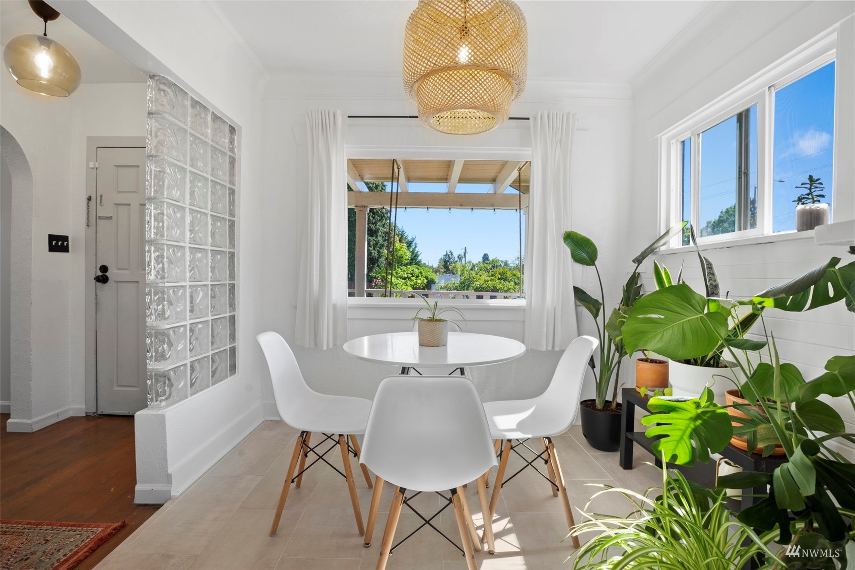 4632 Fawcett Avenue Tacoma, WA 98408 - Photo 7 of 35 a dining room with furniture a potted plant and a chandelier