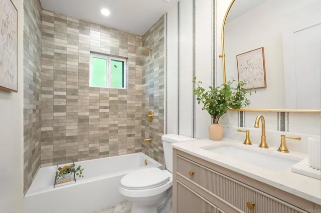 a bath room with a toilet a sink and a bath tub