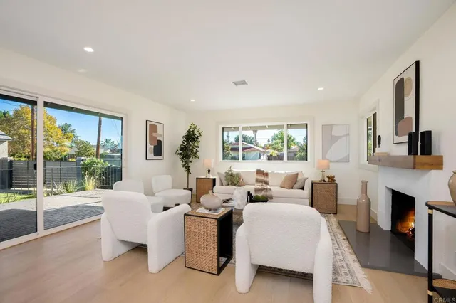 a living room with furniture large window and a fireplace