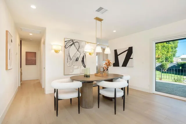 a view of a dining room with furniture wooden floor and a chandelier