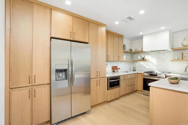 a kitchen with cabinets and stainless steel appliances