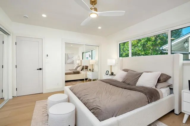 a bedroom with a bed and a large window