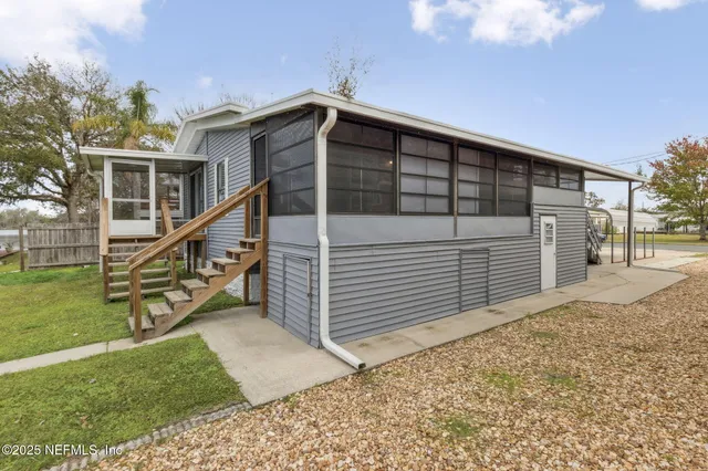 a view of a house with a yard and sitting area