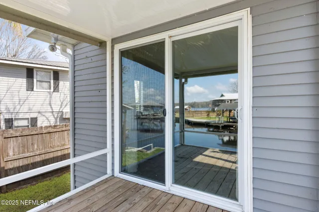 a view of a white house with a yard and sitting space
