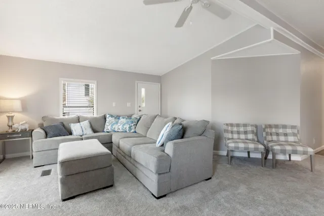 a living room with furniture and a lamp