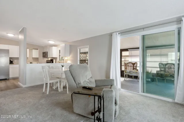 a kitchen with stainless steel appliances granite countertop a refrigerator a stove a sink and a microwave