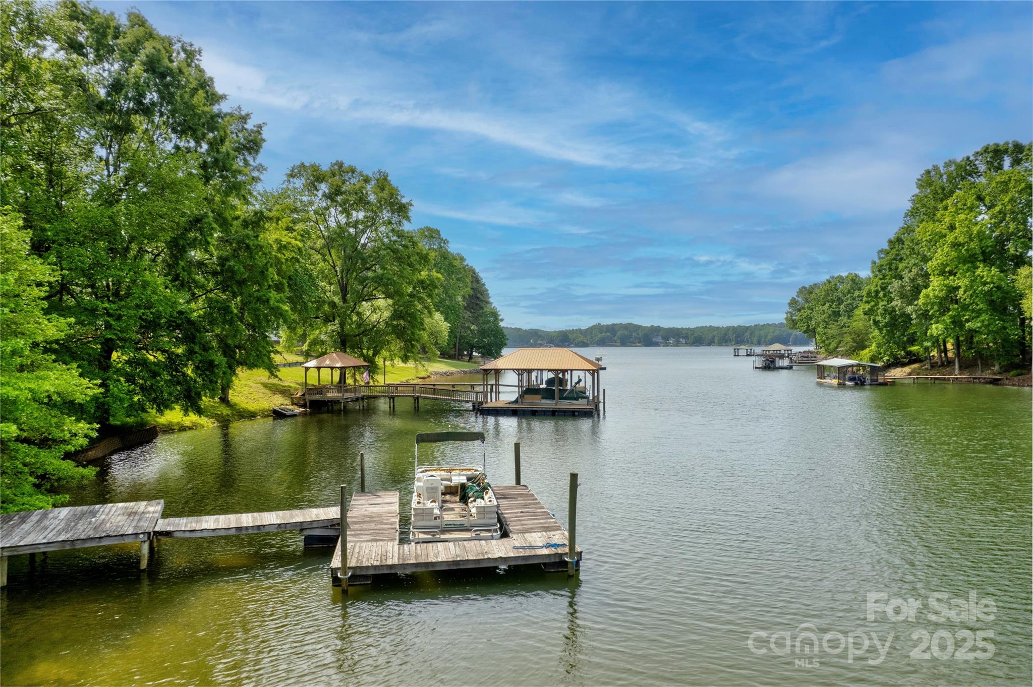 669 Kenway Loop Mooresville, NC 28117 - Photo 7 of 11 a view of a lake with boats and trees in the background