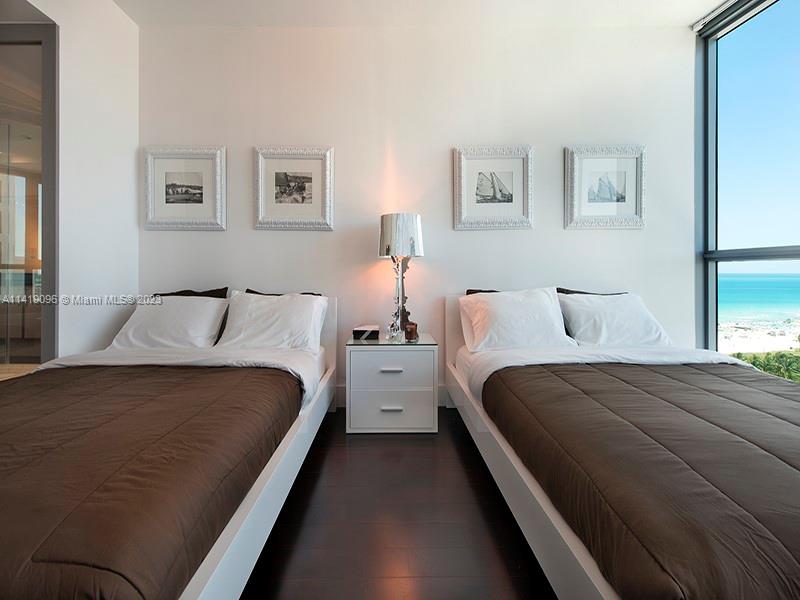 101 20th Street, Unit 2002 Miami Beach, FL 33139 - Photo 12 of 16 a bedroom with two beds and white walls