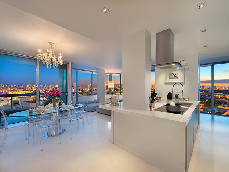 101 20th Street, Unit 2002 Miami Beach, FL 33139 - Photo 3 of 16 a living room with furniture a chandelier and a flat screen tv