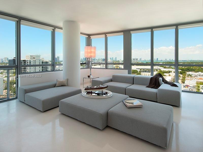 101 20th Street, Unit 2002 Miami Beach, FL 33139 - Photo 5 of 16 a living room with furniture and floor to ceiling windows