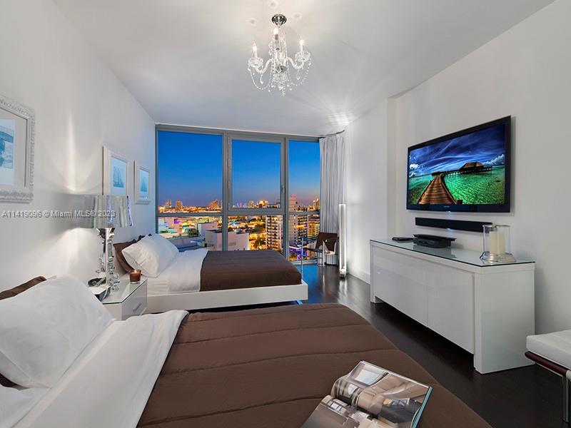 101 20th Street, Unit 2002 Miami Beach, FL 33139 - Photo 10 of 16 a living room with furniture and a flat screen tv