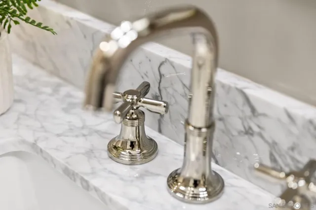 a bedroom with bed and a large window