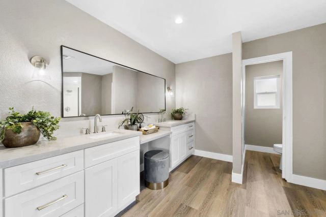 an empty room with wooden floor and window