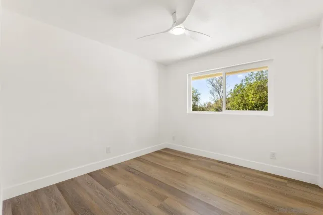 a view of a yard with yellow lighting