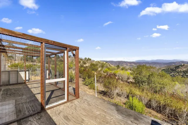 a view of a white house with a yard