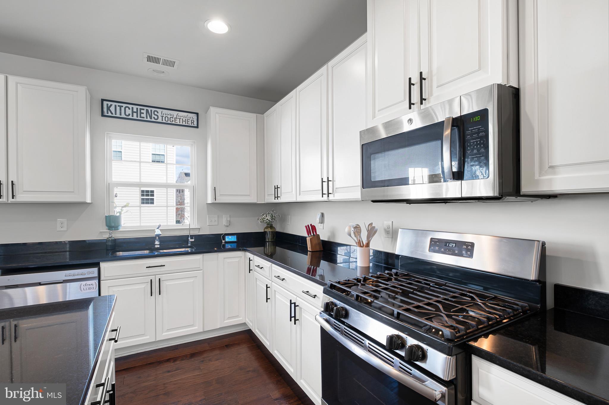 449 Smee Road Middletown, DE 19709 - Photo 11 of 31 a kitchen with stainless steel appliances a sink a stove cabinets and a microwave
