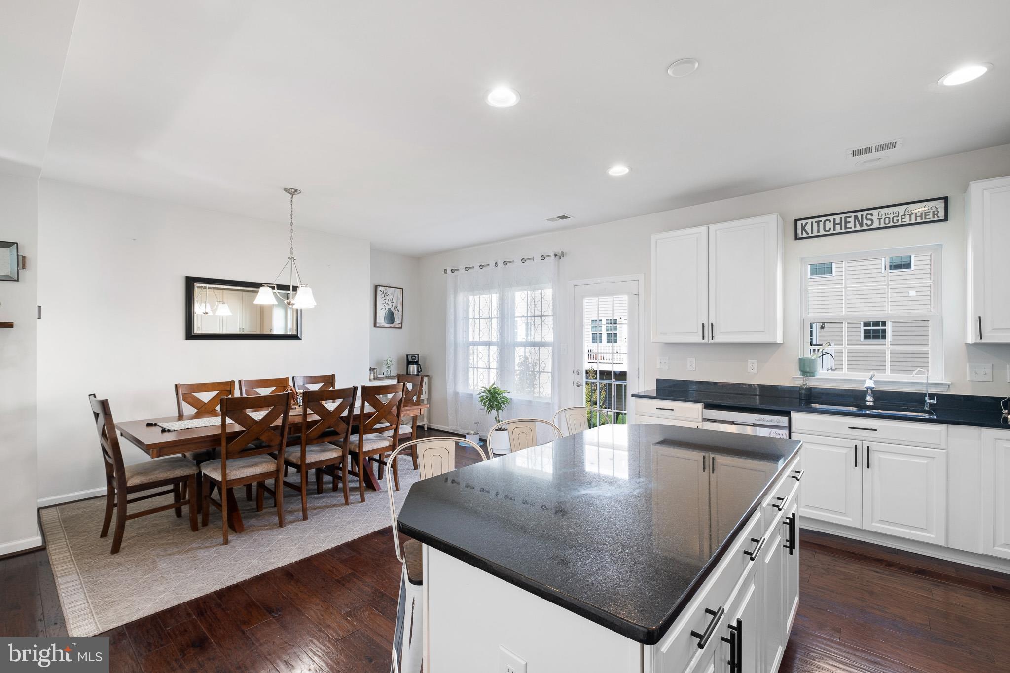 449 Smee Road Middletown, DE 19709 - Photo 13 of 31 a kitchen with stainless steel appliances granite countertop a stove a sink a table and chairs