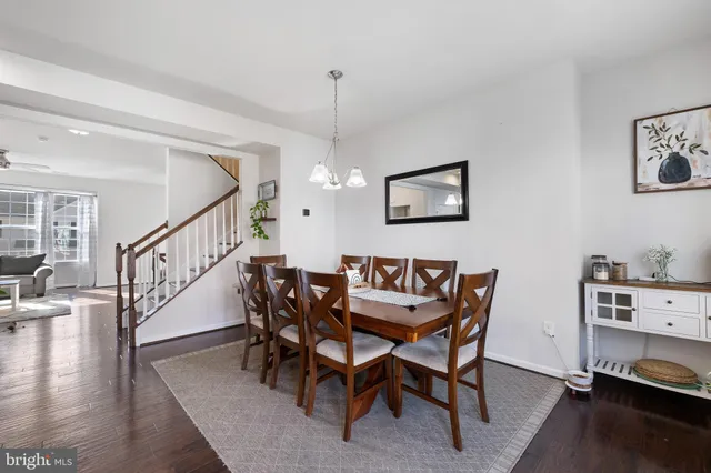 a view of a dining room with furniture wooden floor and a chandelier