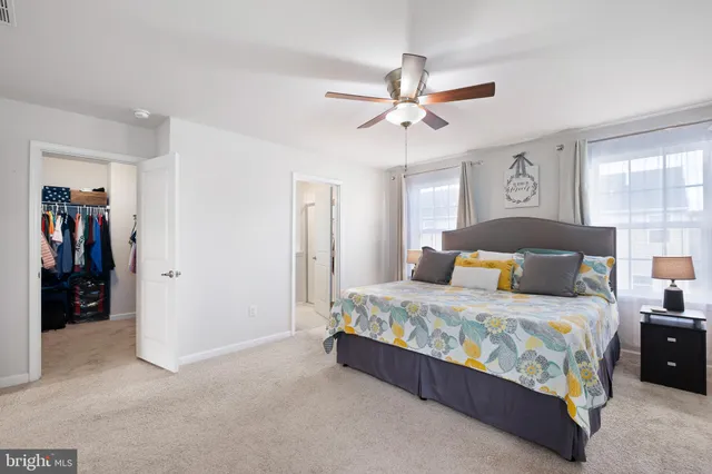 a bedroom with a bed and a ceiling fan