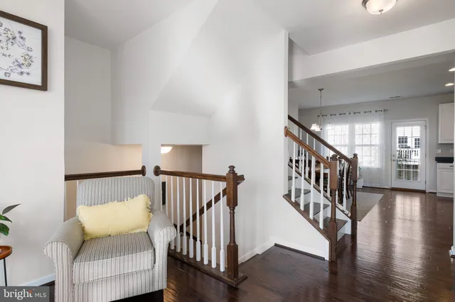 a view of hallway with wooden floor and stairs